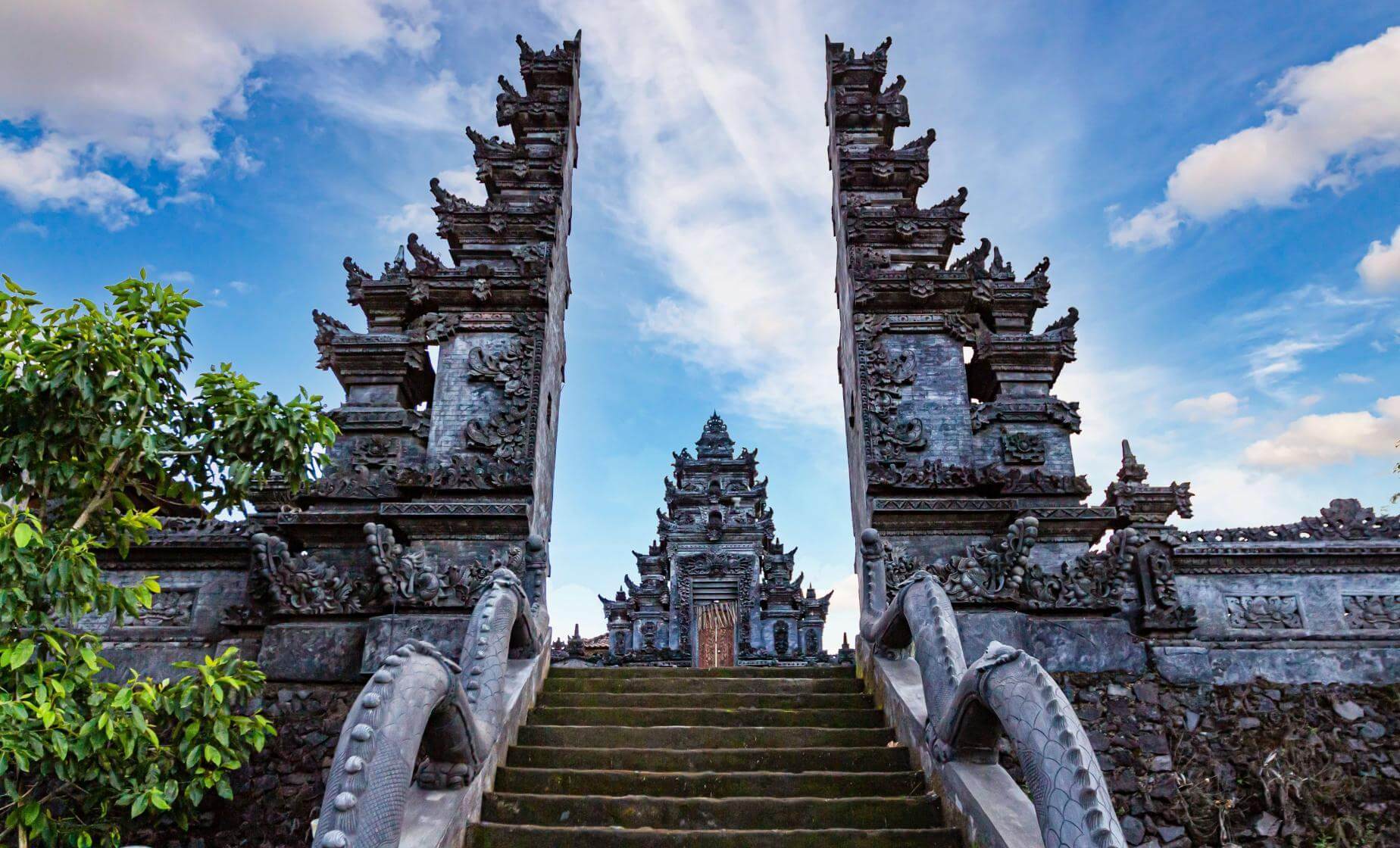 Serene Balinese temple with traditional stone architecture and ornate carved entrance