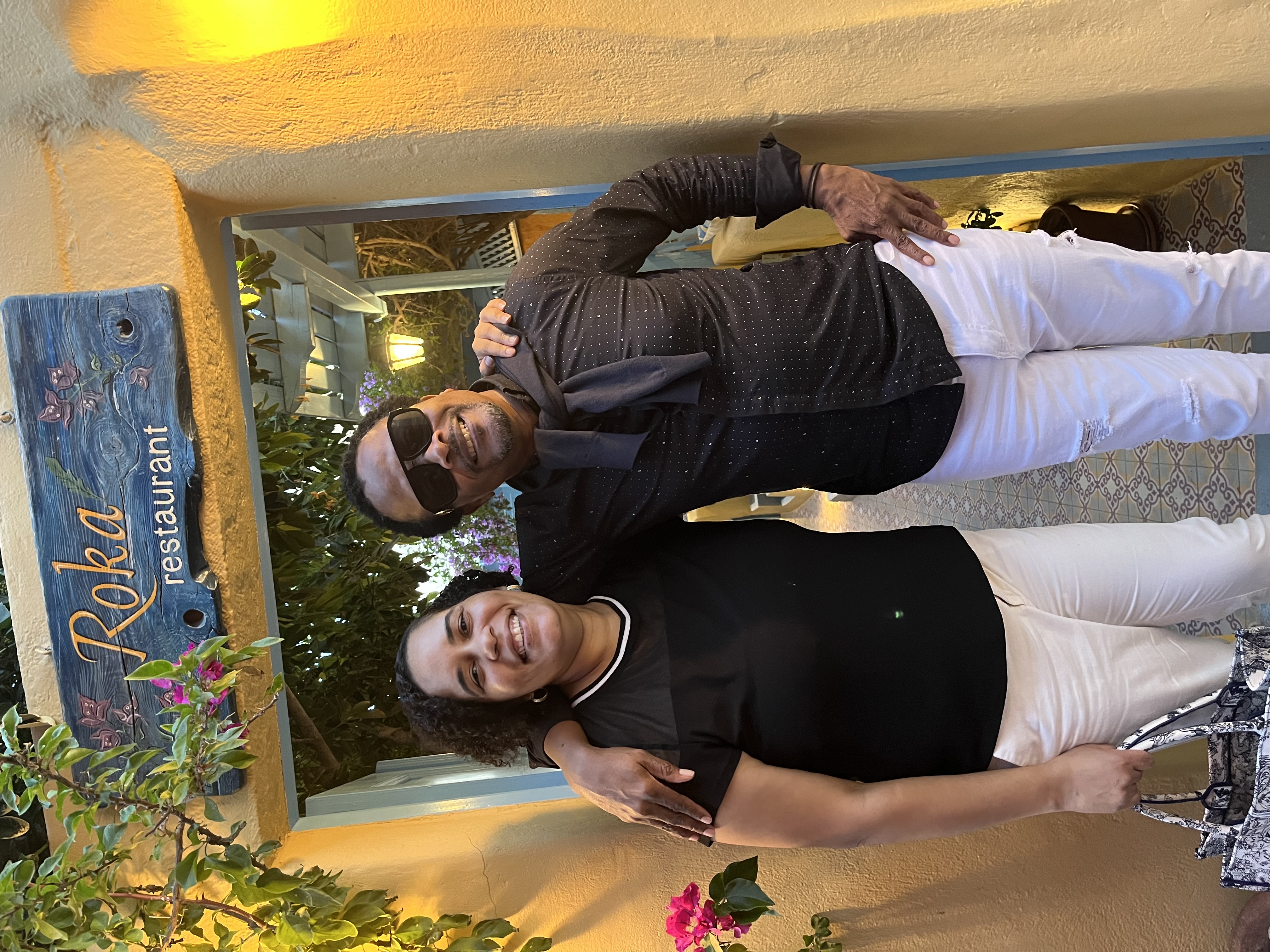 Caroline and Pedro, hosts of Marvelous Expeditions, smiling at Roka restaurant