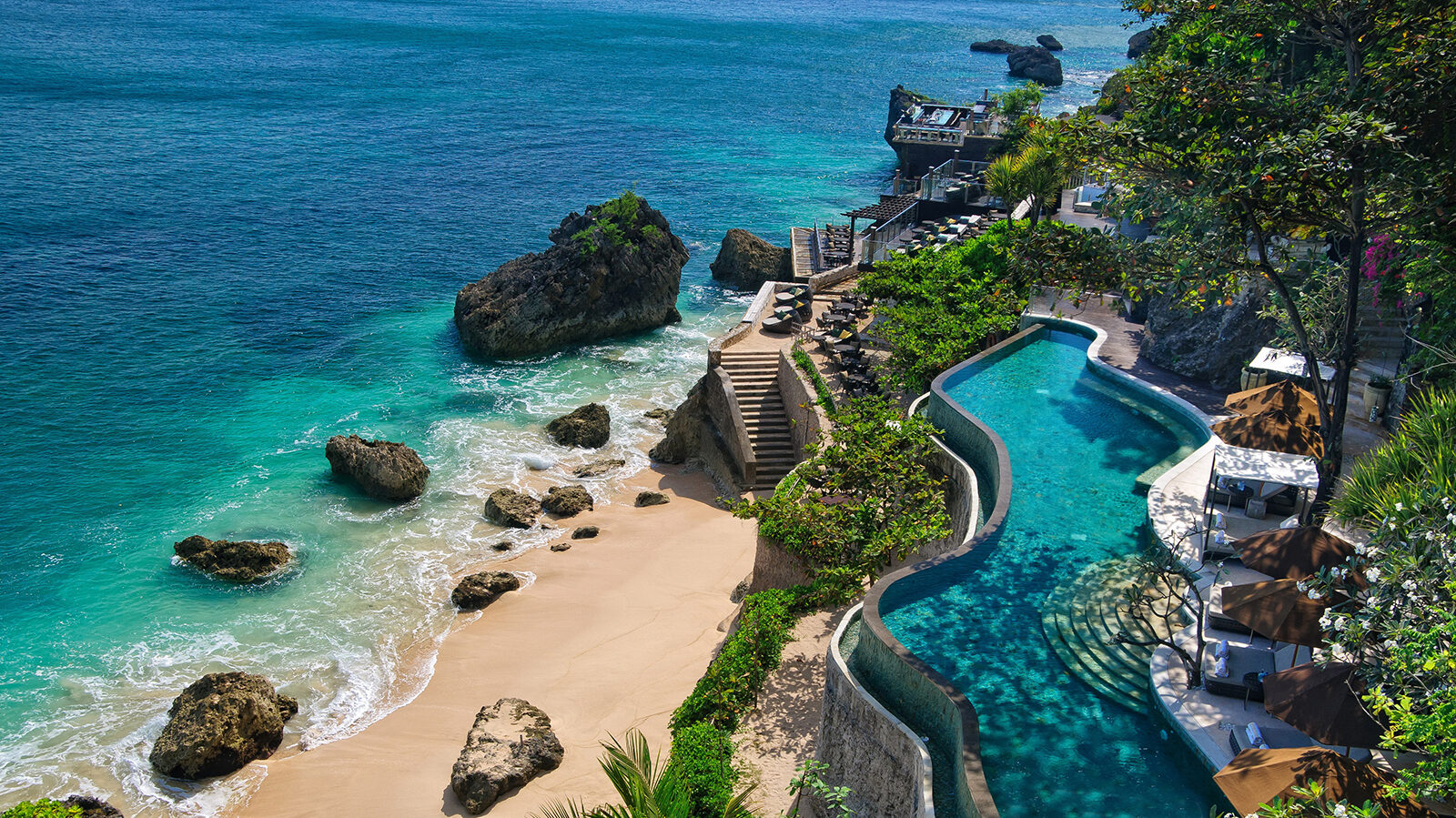 Luxurious Bali resort with infinity pool overlooking a turquoise beach